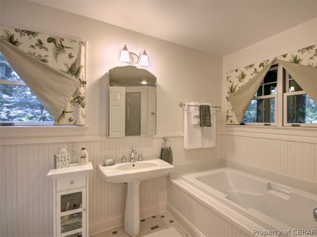 1178 Providence Road Deltaville, VA 23043 - Photo 34 of 50 Master bath with wainscoting, pedestal sink and deep soaking tub.