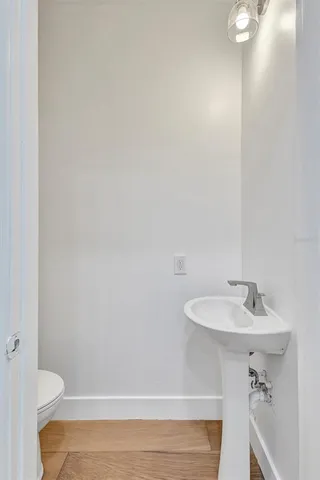 a bathroom with a sink a toilet and a mirror