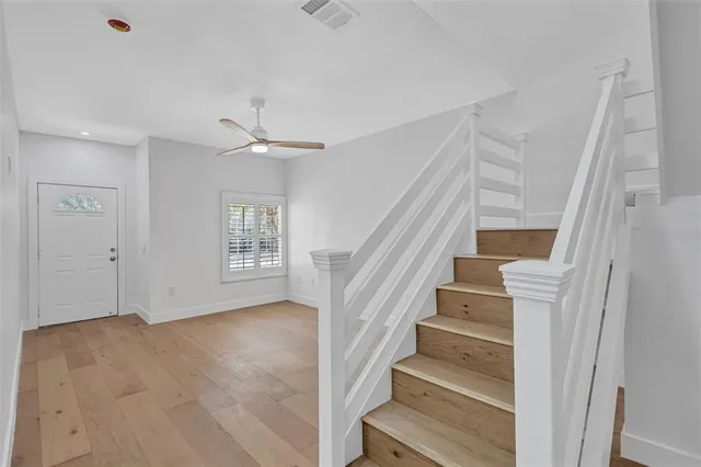 a view of entryway and hall with wooden floor