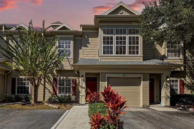 a view of a house with swimming pool and sitting area