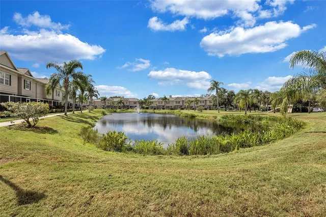 a view of a lake with houses in the back