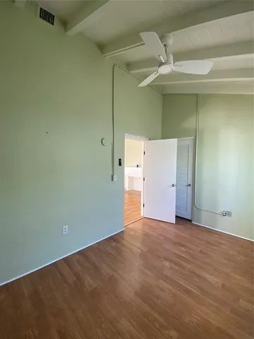 an empty room with a wooden cabinet
