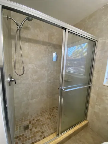 a bathroom with a glass shower door