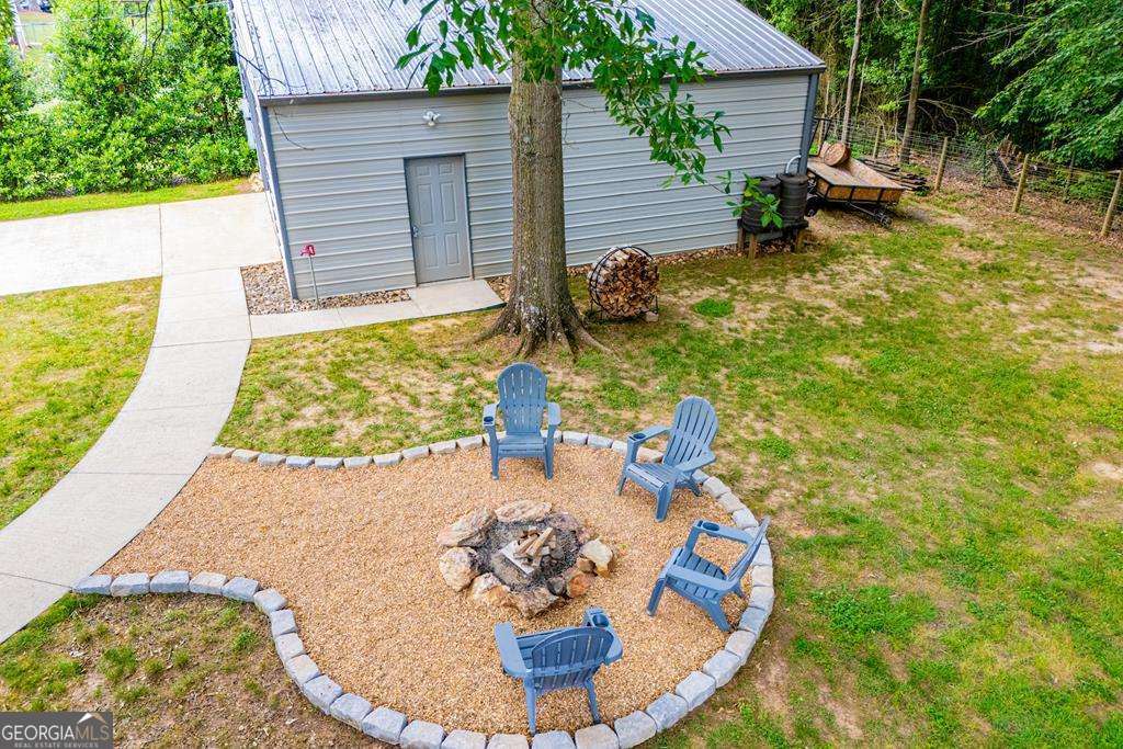 2 Pine Hill Drive Ranburne, AL 36273 - Photo 71 of 91 a backyard of a house with table and chairs