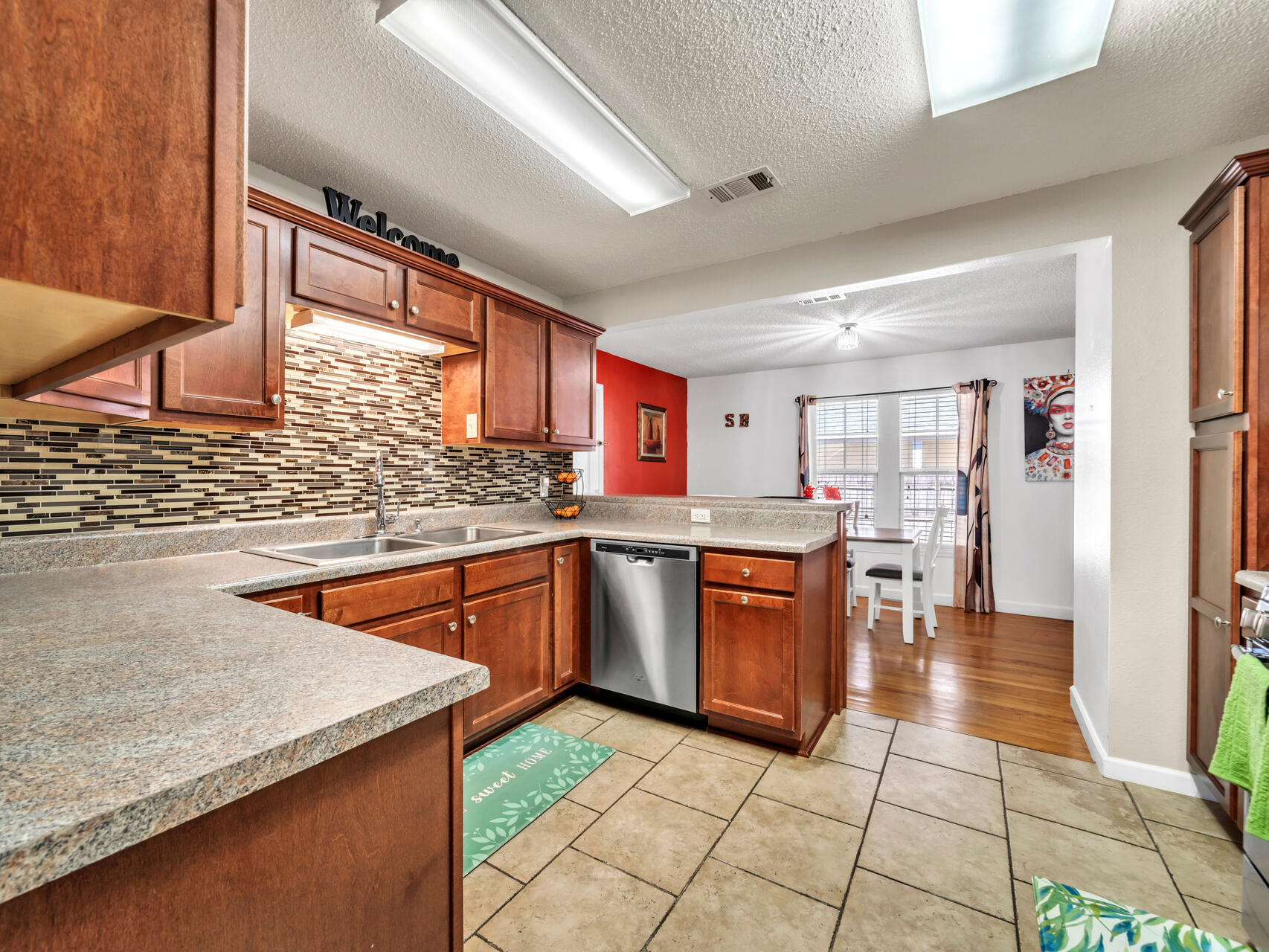 607 Alabama Street Crestview, FL 32536 - Photo 11 of 31 a kitchen with stainless steel appliances granite countertop a sink and cabinets