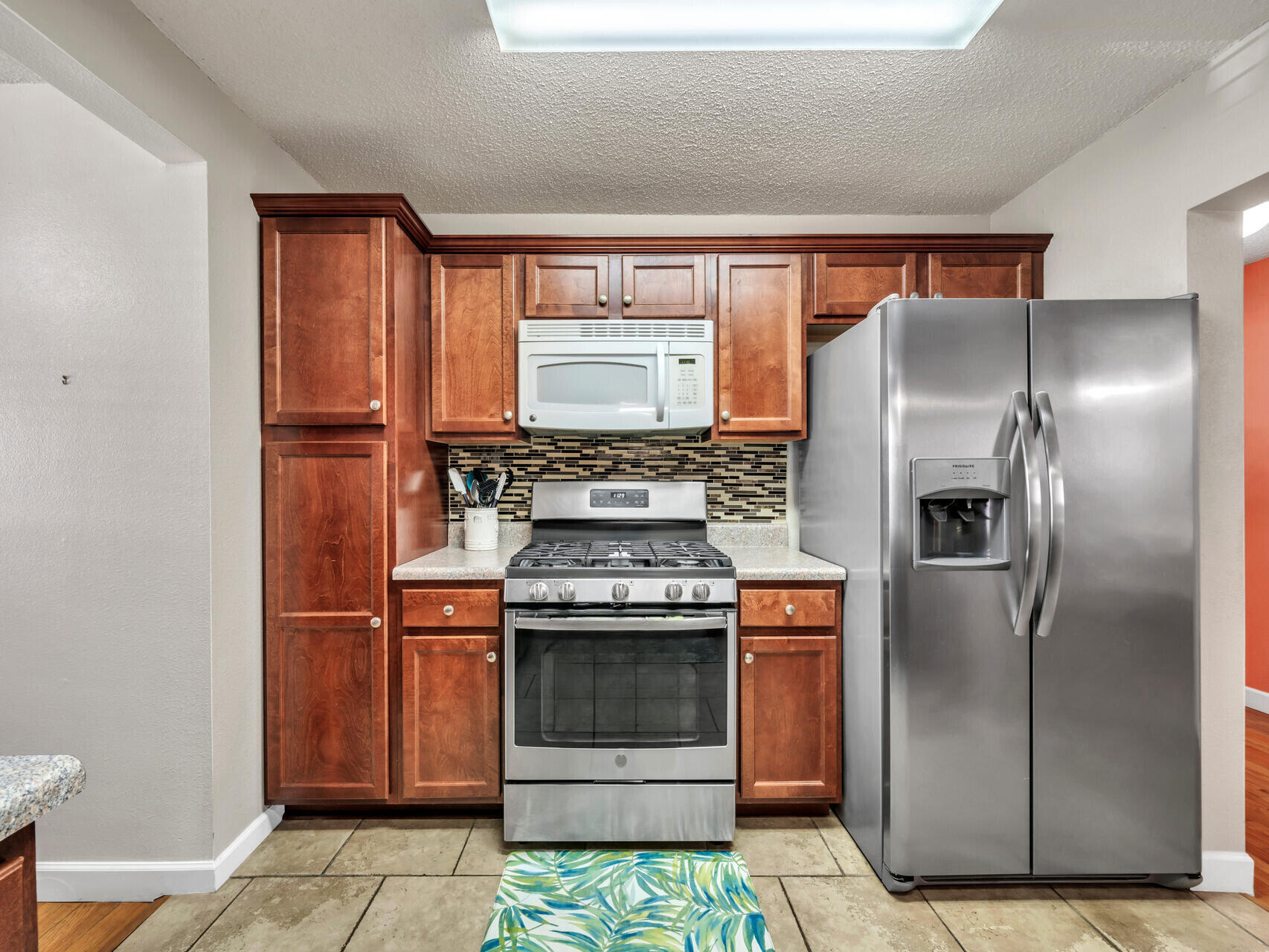 607 Alabama Street Crestview, FL 32536 - Photo 12 of 31 a kitchen with a stove top oven and refrigerator