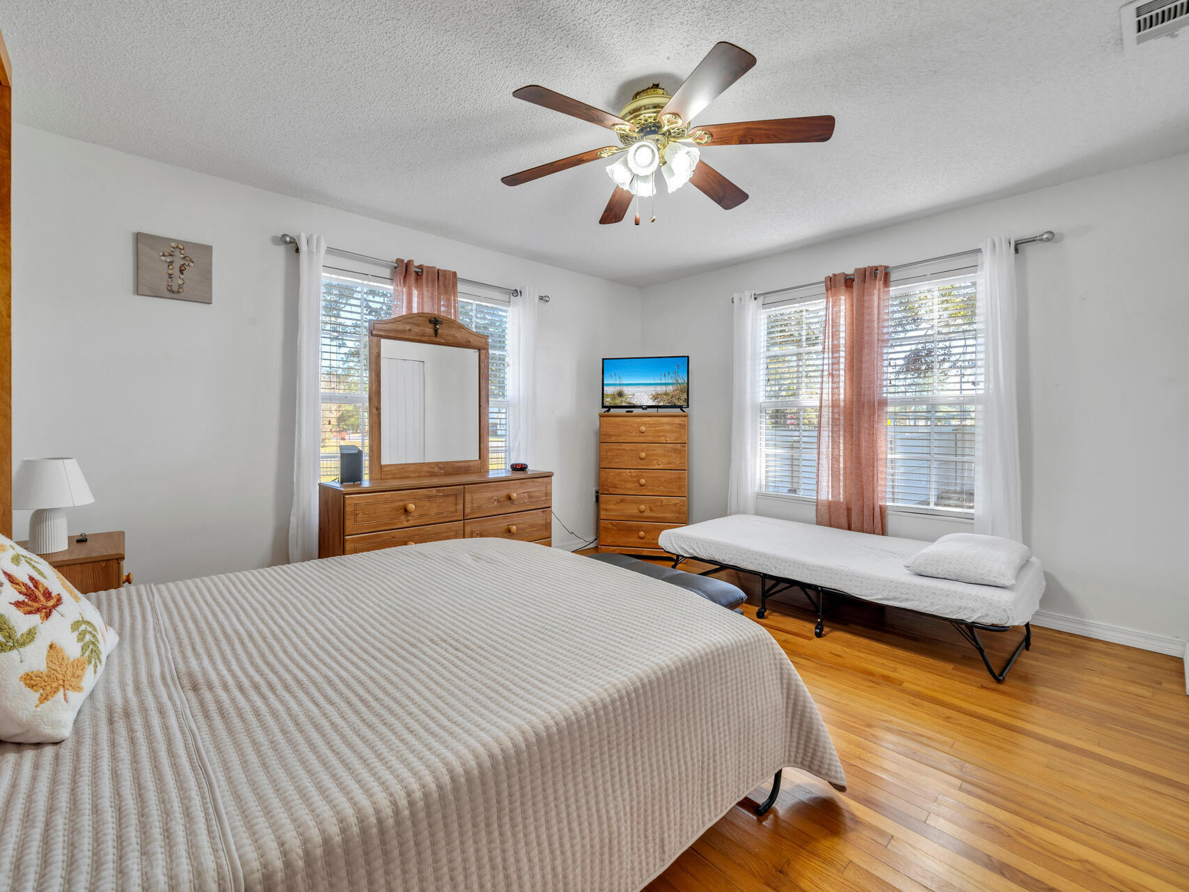 607 Alabama Street Crestview, FL 32536 - Photo 13 of 31 a bedroom with a bed and wooden floor