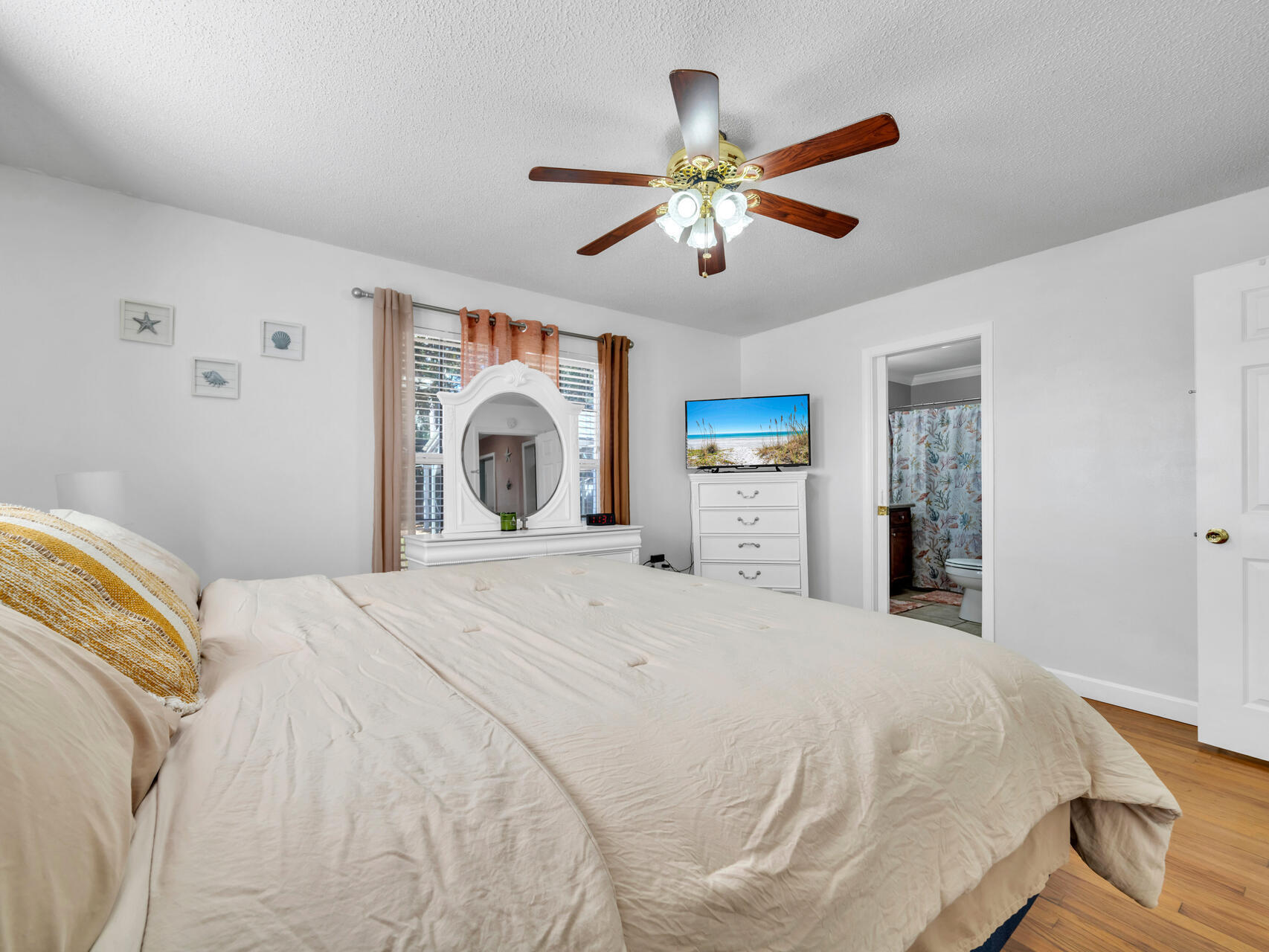 607 Alabama Street Crestview, FL 32536 - Photo 17 of 31 a bedroom with a large bed and a chandelier