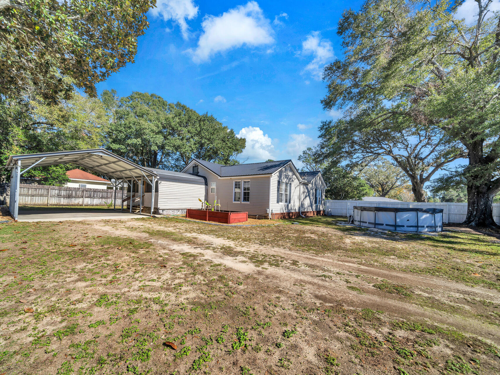 607 Alabama Street Crestview, FL 32536 - Photo 27 of 31 a view of a house with a yard and large tree