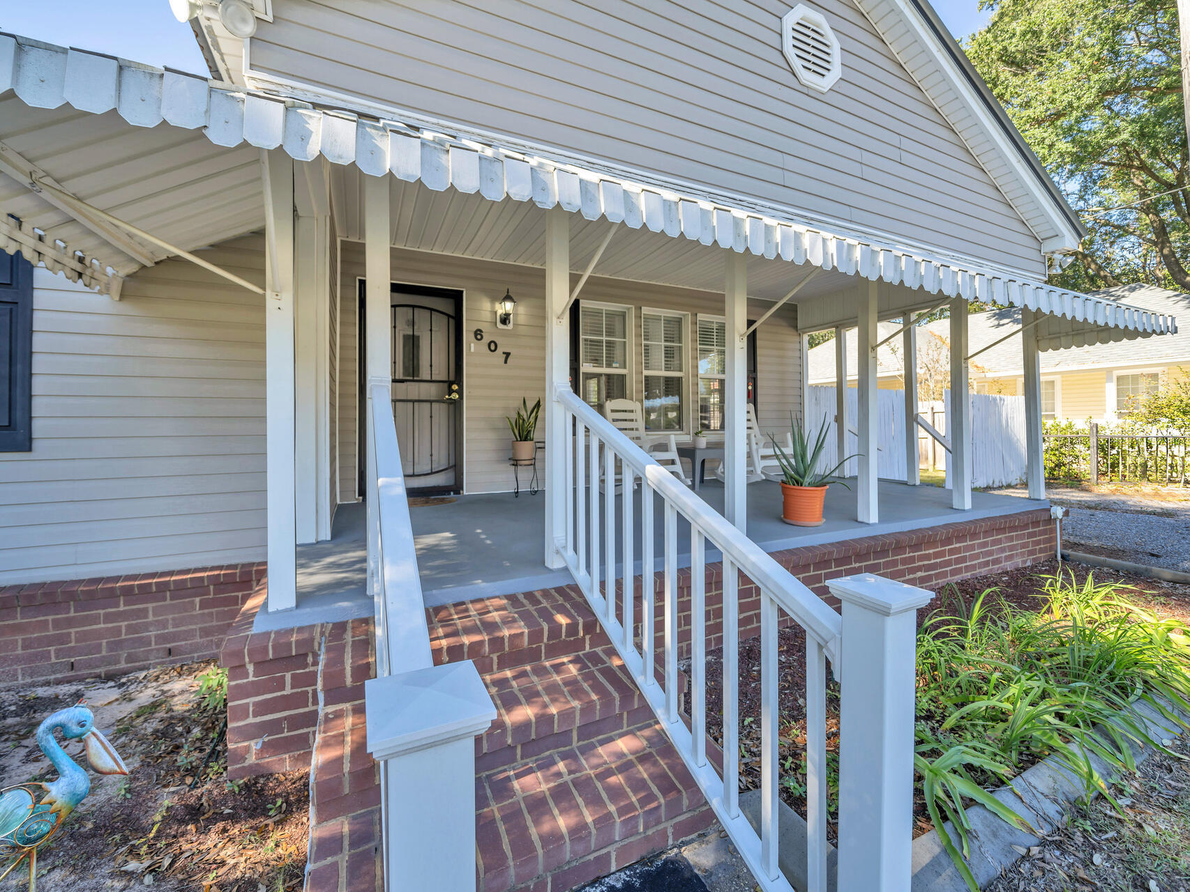 607 Alabama Street Crestview, FL 32536 - Photo 3 of 31 a view of a house with balcony and wooden floor