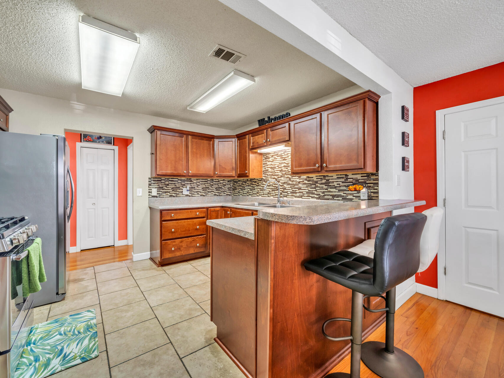 607 Alabama Street Crestview, FL 32536 - Photo 10 of 31 a kitchen with stainless steel appliances granite countertop a refrigerator and a stove top oven