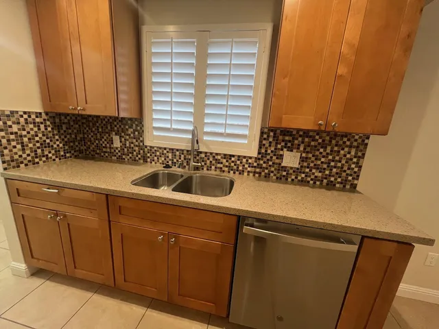 a kitchen with a sink and cabinets