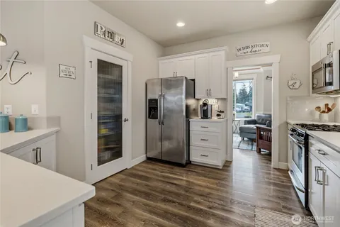 a kitchen with stainless steel appliances granite countertop a stove a sink and a microwave
