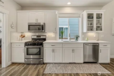 a kitchen with stainless steel appliances a refrigerator stove and microwave