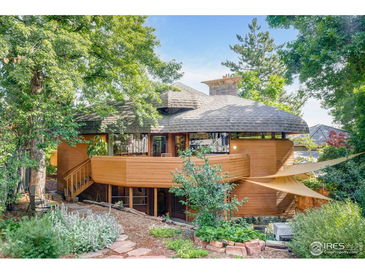 an aerial view of a house with swimming pool and garden