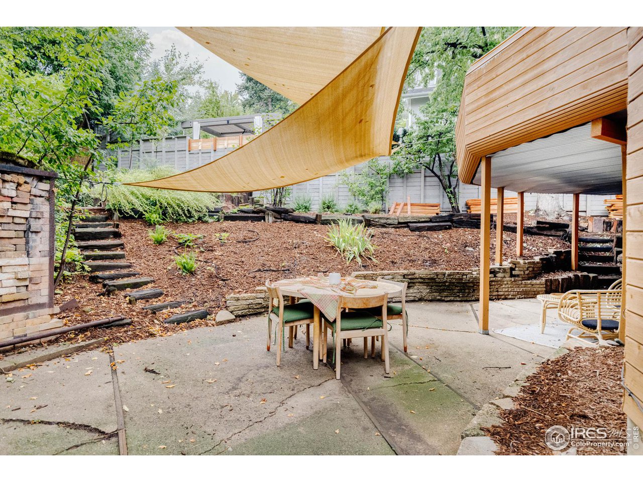 550 College Avenue Boulder, CO 80302 - Photo 27 of 36 a view of a patio with table and chairs under an umbrella