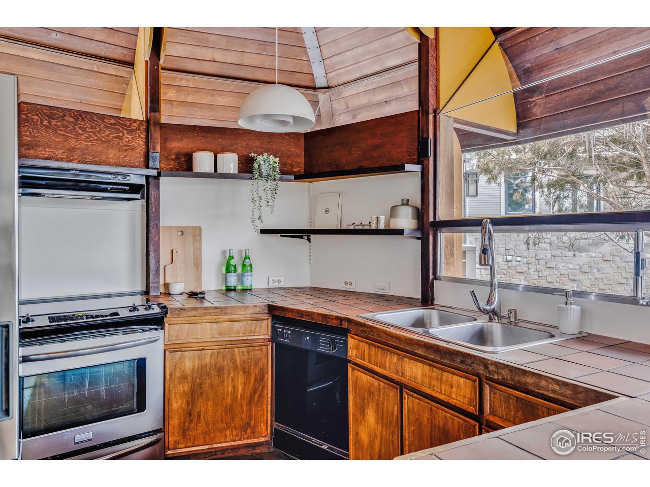 550 College Avenue Boulder, CO 80302 - Photo 10 of 36 a kitchen with stainless steel appliances granite countertop a sink a stove and a microwave