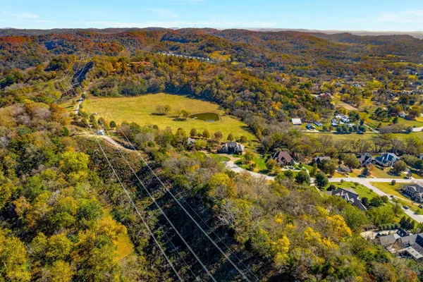 an aerial view of residential houses with trees