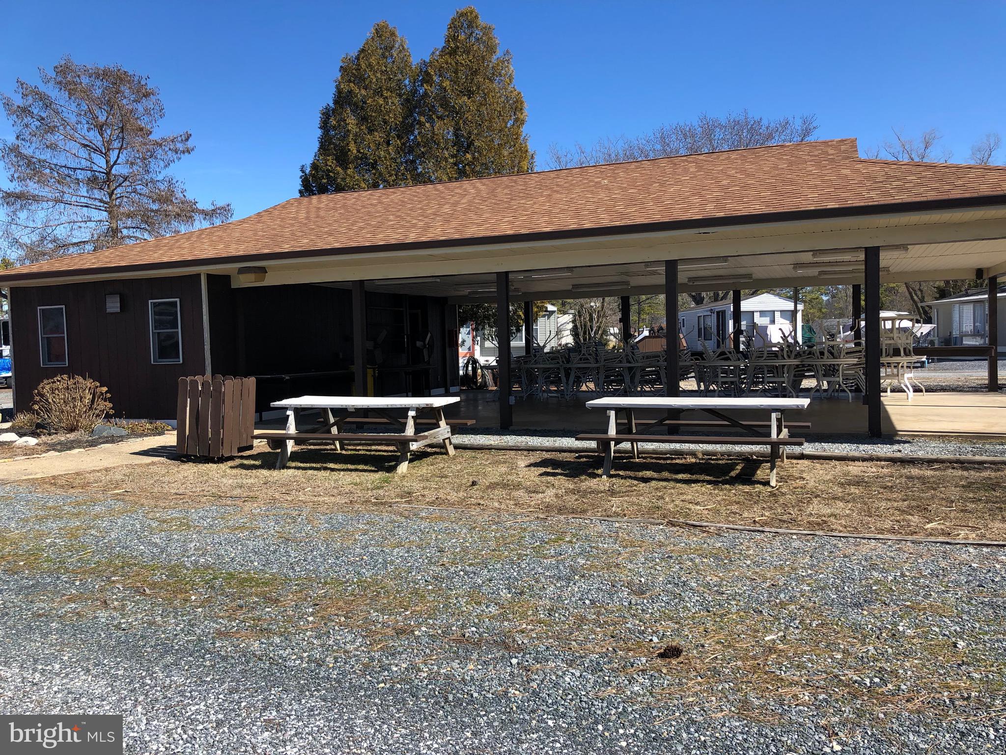 111 Saddler Road, Unit 46F Grasonville, MD 21638 - Photo 18 of 22 a view of a patio with table and chairs and potted plants