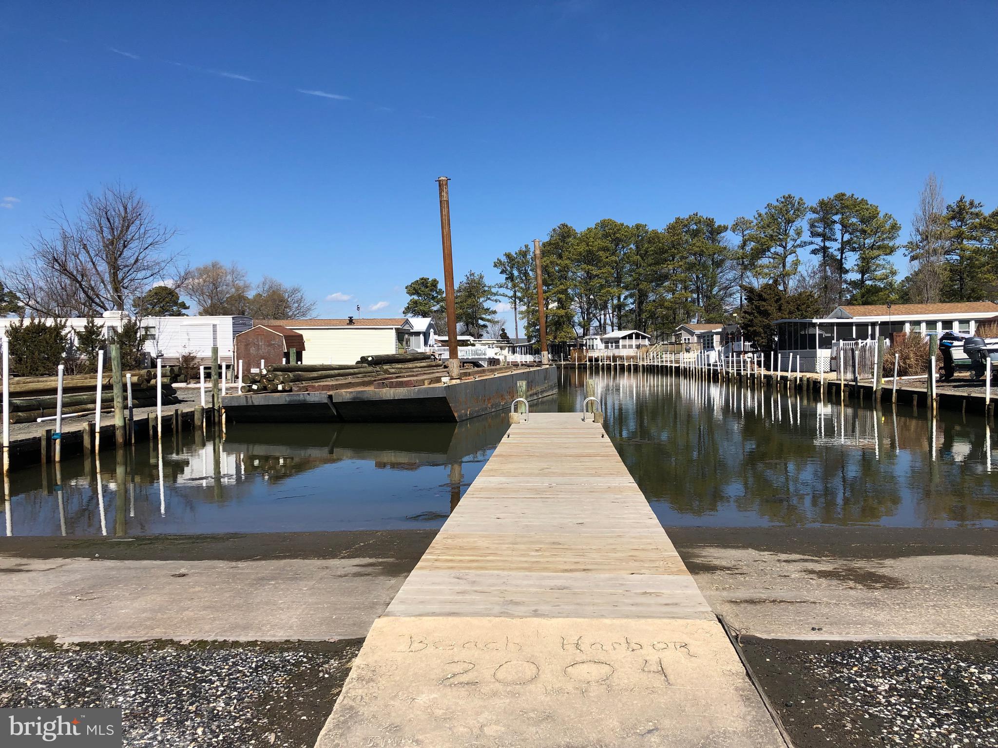 111 Saddler Road, Unit 46F Grasonville, MD 21638 - Photo 6 of 22 a view of a lake with boats and trees in the background
