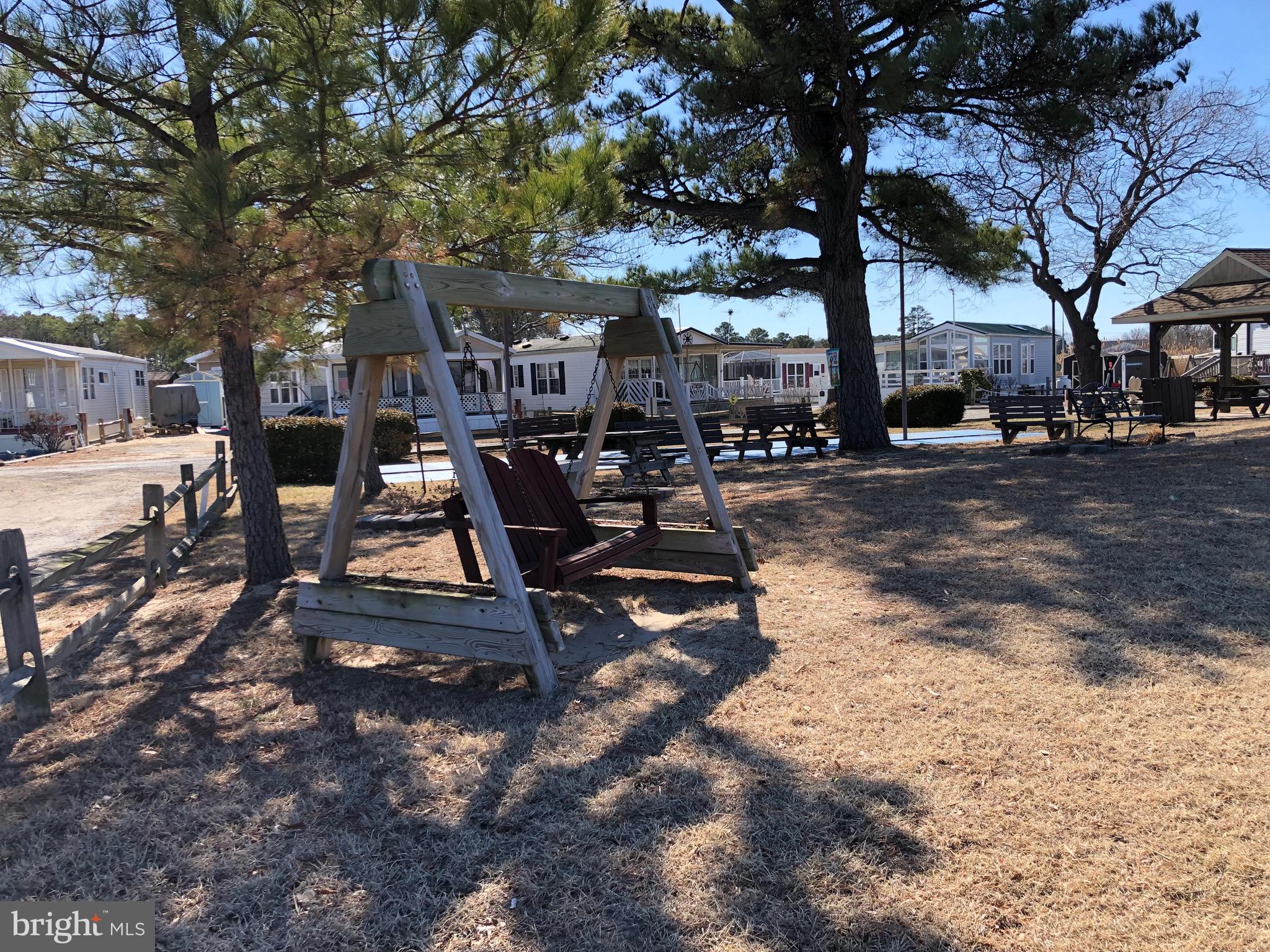 111 Saddler Road, Unit 46F Grasonville, MD 21638 - Photo 9 of 22 a view of a park with bench and trees
