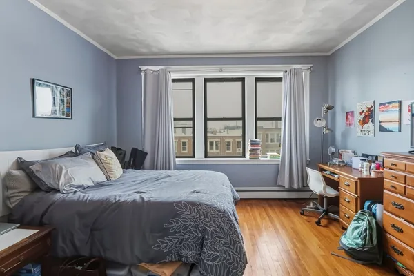 a bed sitting in a bedroom next to a window