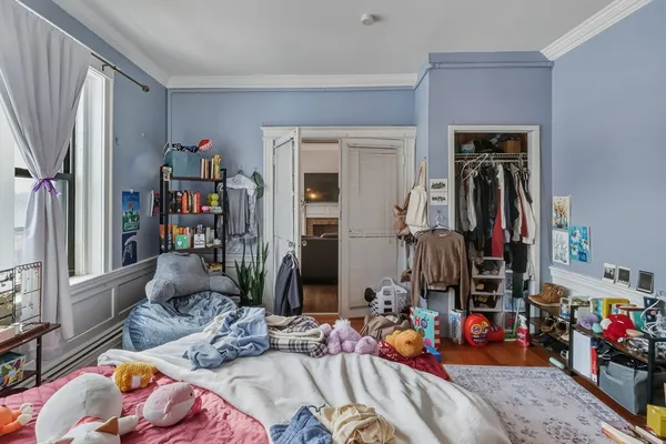 a bedroom with two beds and a window