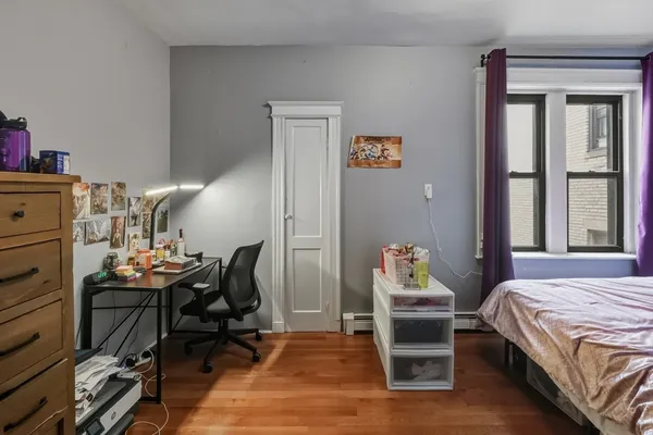 a bedroom with a bed and a lounge chair