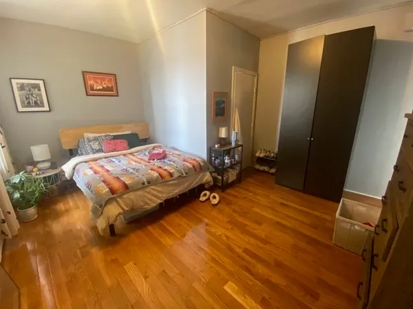 a bedroom with a bed and a mirror