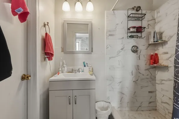 a bathroom with a sink a mirror and shower