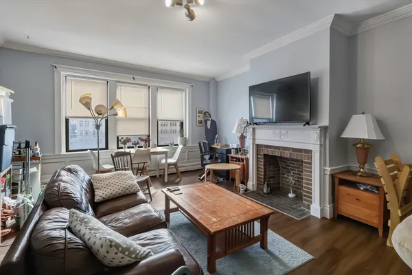 a living room with furniture a flat screen tv and a fireplace