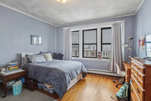 a spacious bedroom with a bed and a window