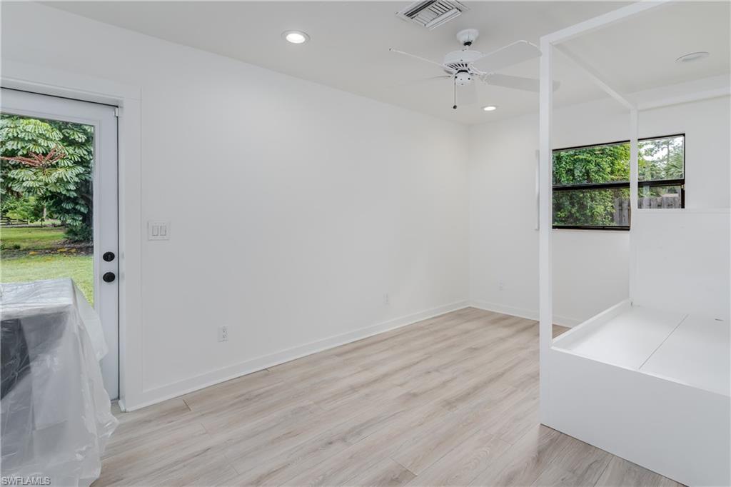 3301 31st Avenue Southwest Naples, FL 34117 - Photo 14 of 22 an empty room with a window and a ceiling fan