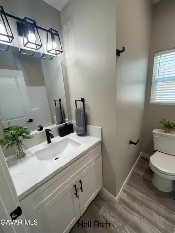 a bathroom with a sink toilet and mirror