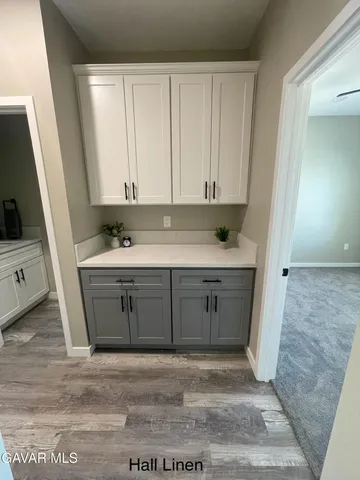 a view of cabinets a sink and a stove in a room