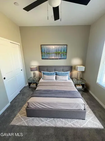 a spacious bedroom with a bed and window