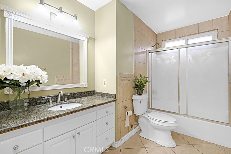 4340 Highland Avenue Oxnard, CA 93033 - Photo 3 of 19 a bathroom with a granite countertop sink a toilet and shower