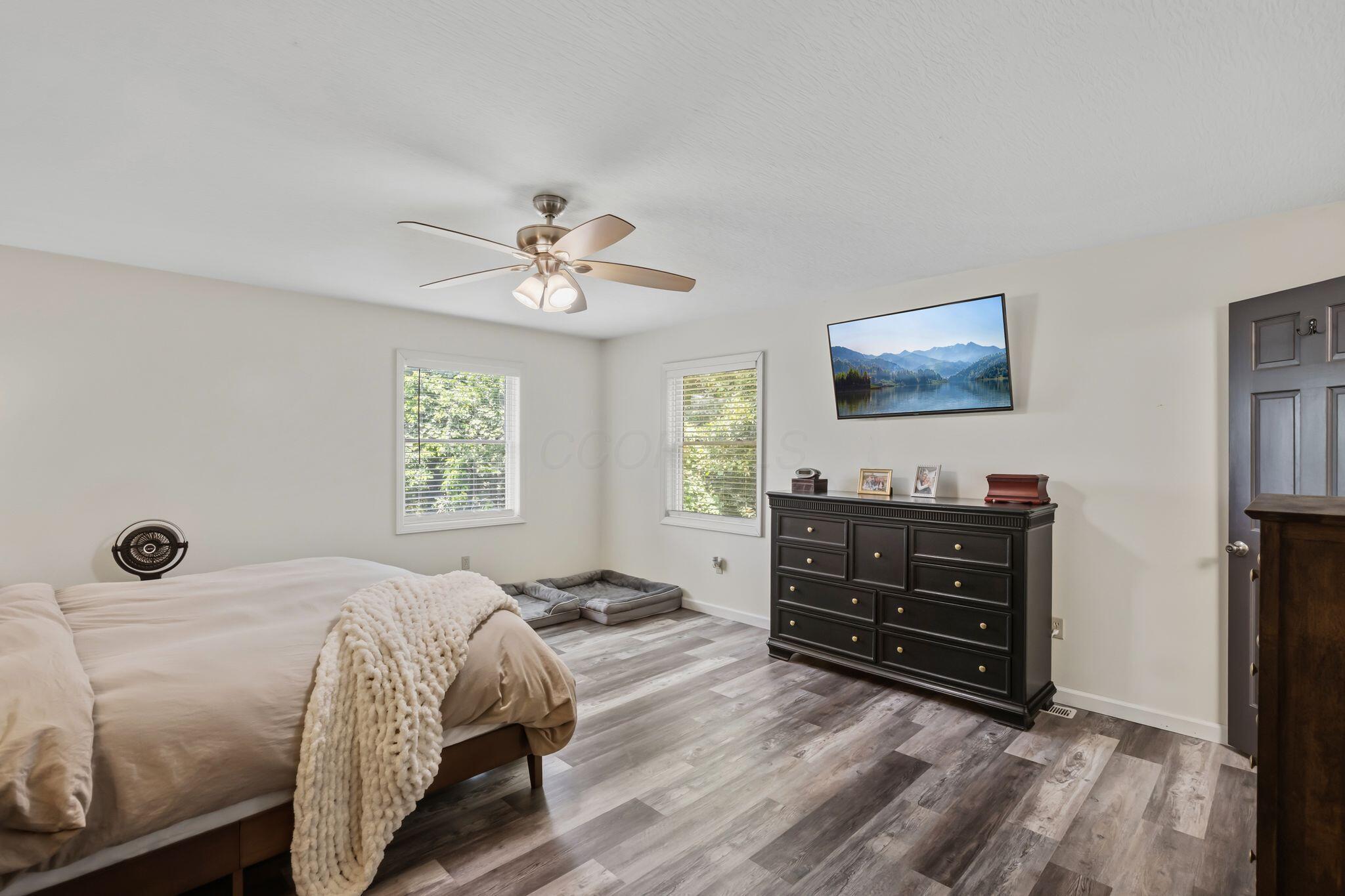 10446 Rich Hollow Road Southwest Lancaster, OH 43130 - Photo 45 of 83 Room featuring wood-finish flooring, white walls, and a ceiling fan with integrated lighting