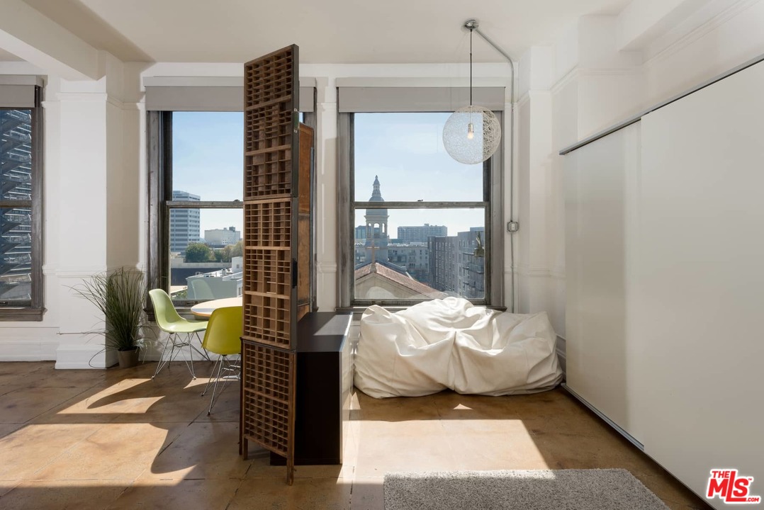 108 West 2nd Street, Unit 606 Los Angeles, CA 90012 - Photo 13 of 29 a living room with furniture and a potted plant