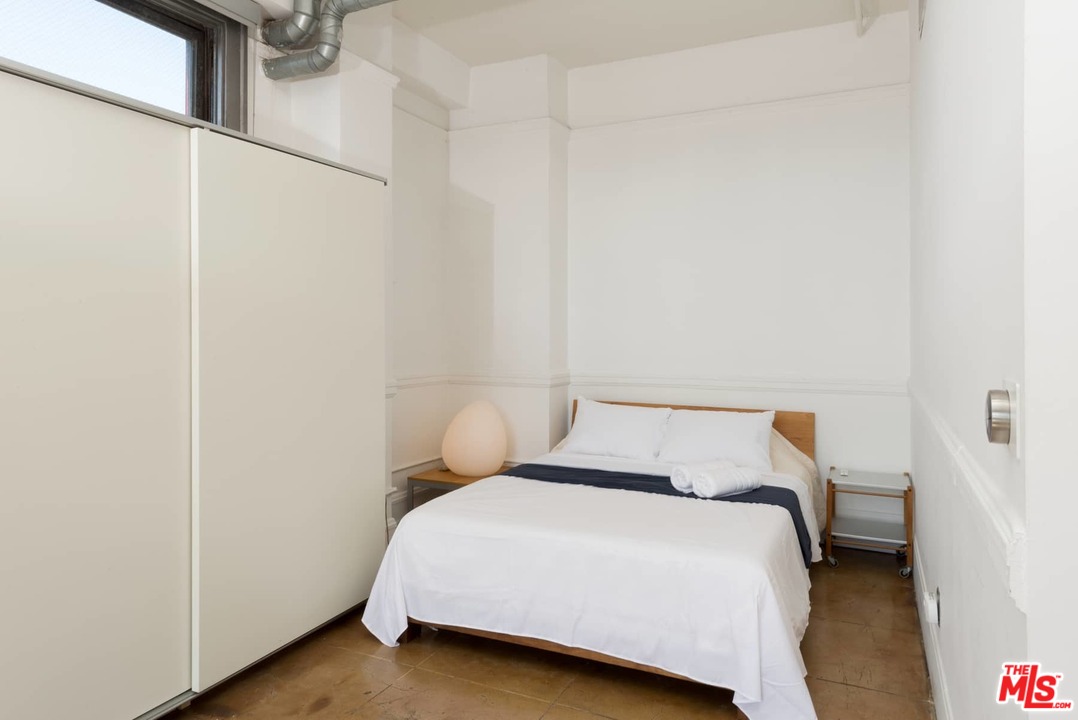 108 West 2nd Street, Unit 606 Los Angeles, CA 90012 - Photo 14 of 29 a bedroom with a bed and a table