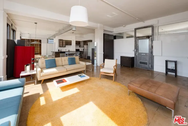 a living room with furniture and a pool table