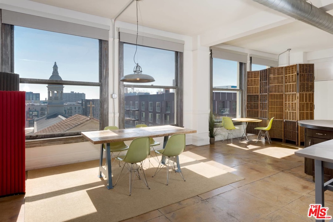 108 West 2nd Street, Unit 606 Los Angeles, CA 90012 - Photo 7 of 29 a living room with furniture a lamp and large window