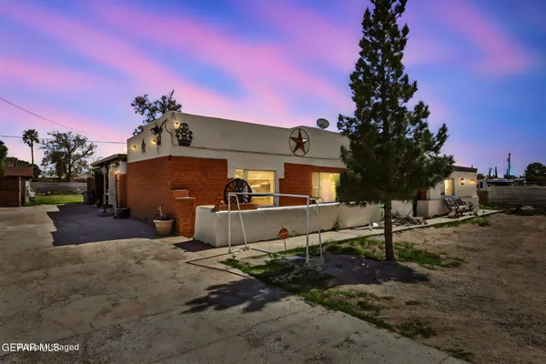 a view of a house with a yard covered in snow