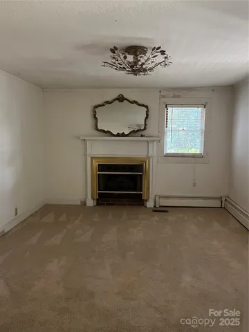 an empty room with a fireplace
