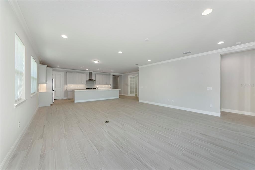5798 Long Shore Loop Sarasota, FL 34238 - Photo 11 of 40 a view of a kitchen with kitchen island white cabinets and wooden floor