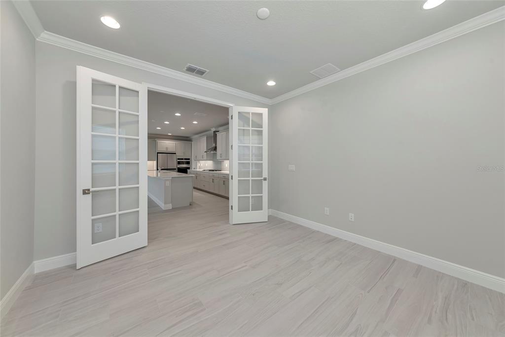 5798 Long Shore Loop Sarasota, FL 34238 - Photo 12 of 40 wooden floor in an empty room with a window