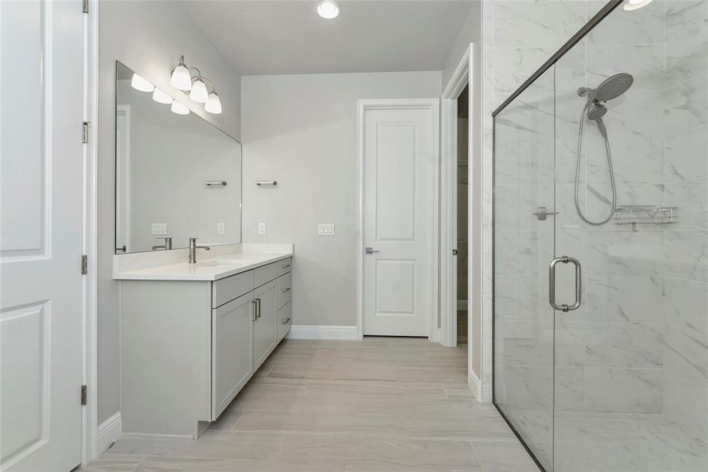 5798 Long Shore Loop Sarasota, FL 34238 - Photo 16 of 40 a spacious bathroom with a double vanity sink mirror and shower
