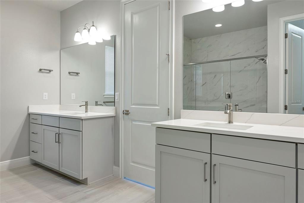 5798 Long Shore Loop Sarasota, FL 34238 - Photo 17 of 40 a bathroom with a sink double vanity and a mirror