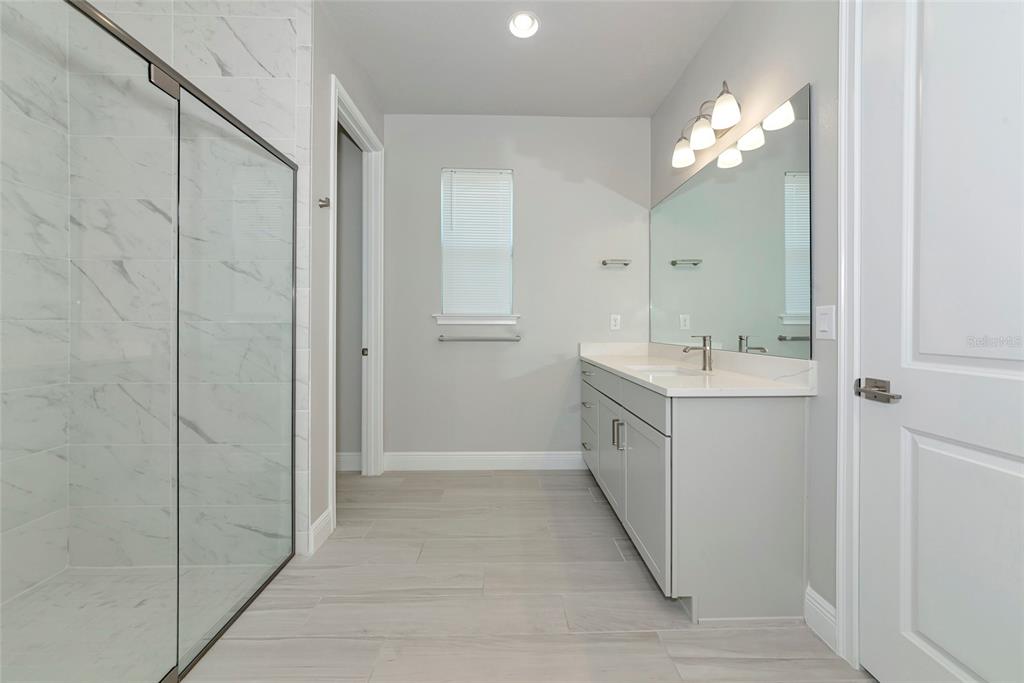 5798 Long Shore Loop Sarasota, FL 34238 - Photo 18 of 40 a bathroom with a double vanity sink mirror and shower