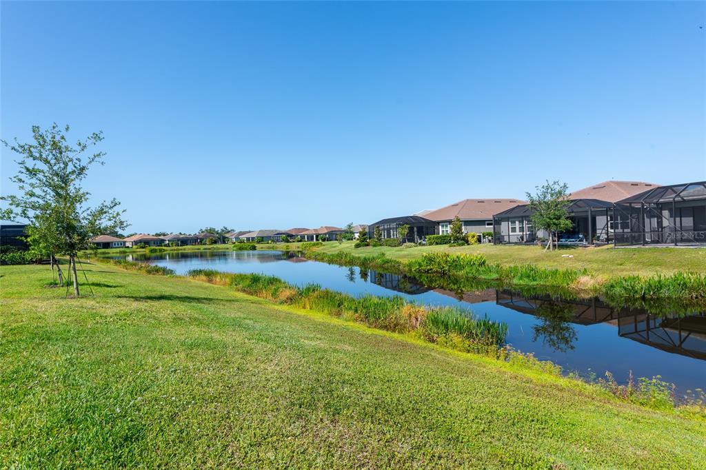 5798 Long Shore Loop Sarasota, FL 34238 - Photo 28 of 40 a view of a lake with a house in the background